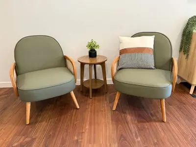 two chairs sitting next to a table with a pillow at Columbia Cabins Cabin 8 in Sonora