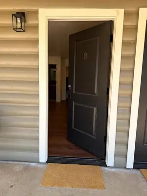 a black door on a house with a hallway at Columbia Cabins Cabin 8 in Sonora