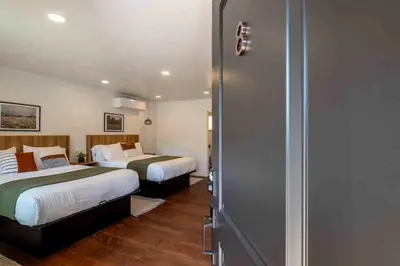 a hotel room with two beds and a closet at Columbia Cabins Cabin 8 in Sonora