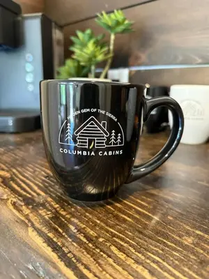 a coffee cup sitting on top of a table at Columbia Cabins Cabin 8 in Sonora