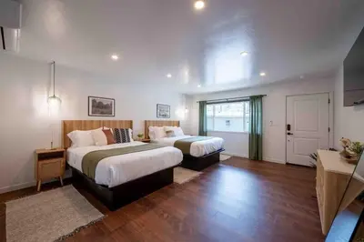 a large bedroom with two beds and a window at Columbia Cabins Cabin 9 in Sonora