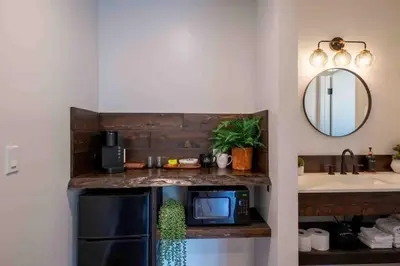 a kitchen with a sink and a microwave at Columbia Cabins Cabin 9 in Sonora