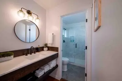a bathroom with a sink and a toilet and a mirror at Columbia Cabins Cabin 9 in Sonora