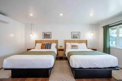 a bedroom with two beds and a window at Columbia Cabins Cabin 9 in Sonora