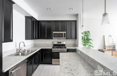 a kitchen with black cabinets and a sink at Local 3BD 3BA with WiFi Parking in Carson City