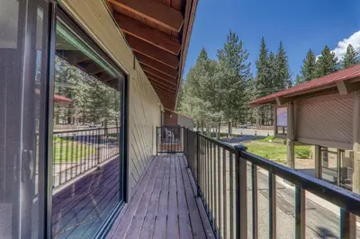 a wooden walkway leading to a porch on a house at Spacious 1BR Condo #218 at Donner Lake Village in Truckee