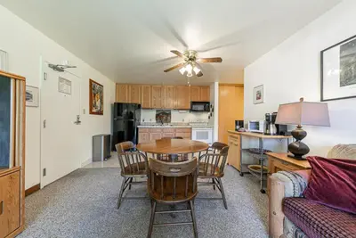 a kitchen and living room with a table and chairs at Spacious 1BR Condo #218 at Donner Lake Village in Truckee
