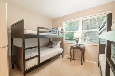 a bedroom with two bunk beds and a desk at Truckee Mountain Retreat Family Friendly 3BR 2BA in Truckee