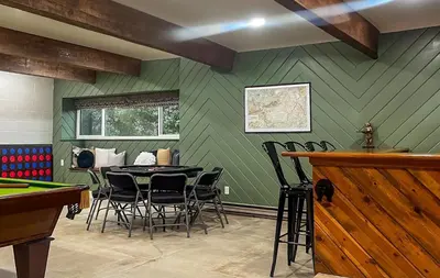 a room with a ping pong table and chairs at Yosemite Family Lodge I Sleeps 11 I Game Room in Oakhurst