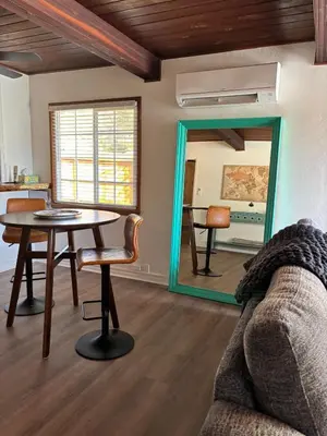 a living room with a table and a mirror at Sam's Place Mariposa - In Town! in Mariposa