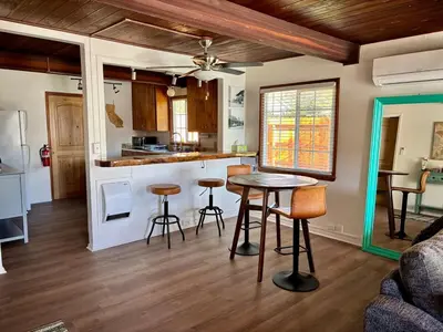 a kitchen and living room with a table and chairs at Sam's Place Mariposa - In Town! in Mariposa
