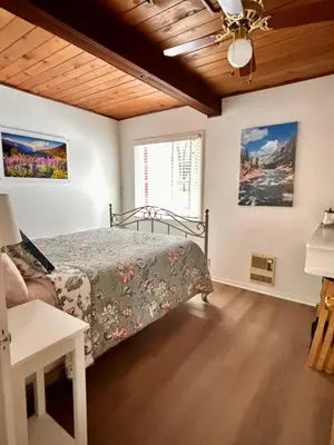 a bedroom with a bed and a ceiling fan at Sam's Place Mariposa - In Town! in Mariposa