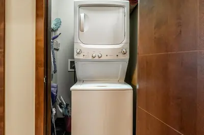 a microwave sitting on top of a washer and dryer at Solstice 8 in Mammoth Lakes