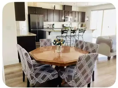 a dining room table with chairs and a kitchen at Spacious, bright and cozy space