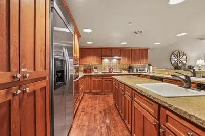a kitchen with wooden cabinets and a stainless steel refrigerator at Spacious Elegance-Kirkwood-Timber Ridge 3 Bedroom residence in Kirkwood