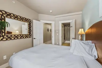 a bedroom with a large white bed and a mirror at Spacious Elegance-Kirkwood-Timber Ridge 3 Bedroom residence in Kirkwood