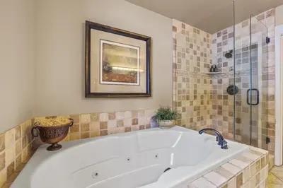 a bath tub in a bathroom with a shower at Spacious Elegance-Kirkwood-Timber Ridge 3 Bedroom residence in Kirkwood