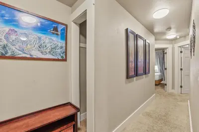 a hallway with paintings on the walls at Spacious Elegance-Kirkwood-Timber Ridge 3 Bedroom residence in Kirkwood