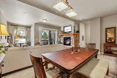 a living room with a table and a fireplace at Spacious Elegance-Kirkwood-Timber Ridge 3 Bedroom residence in Kirkwood