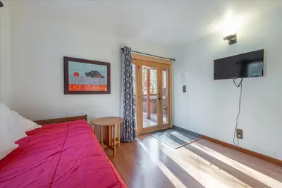 a bedroom with a bed and a flat screen tv at Lakeside Serenity Retreat in Kings Beach