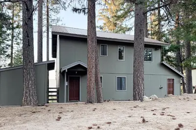 a gray house with trees in front of it at Vernal Vista in Yosemite West