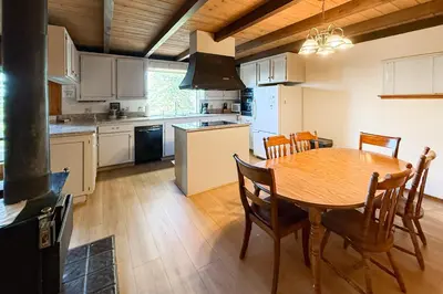 a kitchen with a wooden table and a dining room at Vernal Vista in Yosemite West
