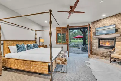 a bedroom with a bed and a fireplace at Schaffers Mill Escape Golf Views and Near Skiing in Truckee