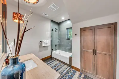 a bathroom with a tub and a vase on a table at Schaffers Mill Escape Golf Views and Near Skiing in Truckee
