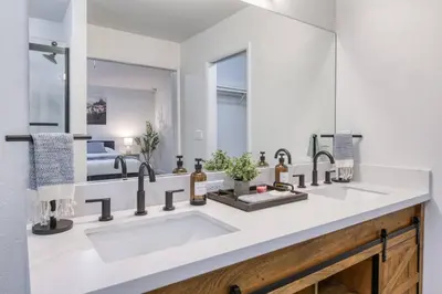 a bathroom with a sink and a mirror at Clovis Retreat Hottub & Firepit in Clovis