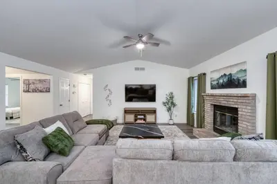 a living room with a couch and a fireplace at Clovis Retreat Hottub & Firepit in Clovis