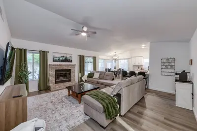 a living room with a couch and a fireplace at Clovis Retreat Hottub & Firepit in Clovis