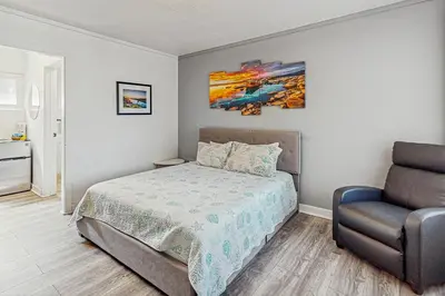 a bedroom with a bed and a chair at The Chalet at Kings Beach Unit 6 in Kings Beach