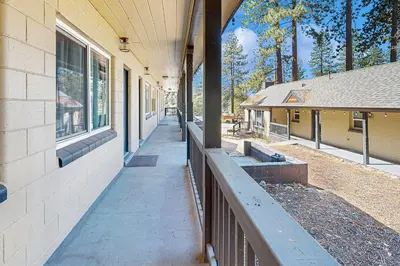 a building with a sidewalk next to a fence at The Chalet at Kings Beach Unit 6 in Kings Beach