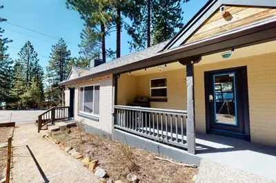 a yellow house with a porch and a door at The Chalet at Kings Beach Unit 4 in Kings Beach