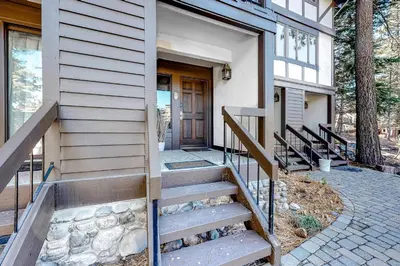 a house with a staircase leading to a door at Tavern 16 in Olympic Valley