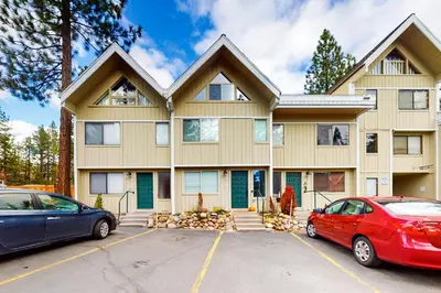 a house with two cars parked in front of it at Sierra Townhome in Incline Village