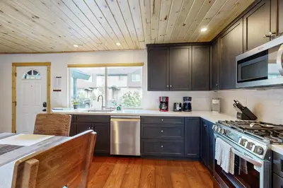 a kitchen with black cabinets and a sink and a stove at Lake Forest Manor in Tahoe City