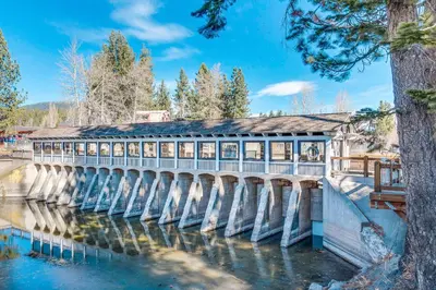 a bridge over a river with a building on it at Lake Forest Manor in Tahoe City