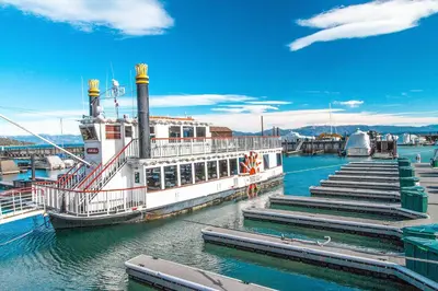 a ferry boat docked at a dock in the water at Lake Forest Manor in Tahoe City