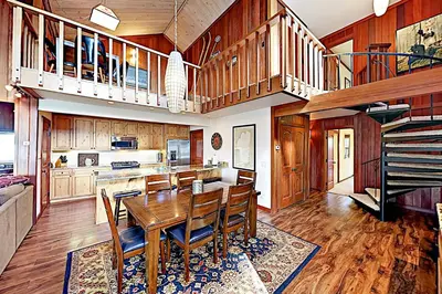 a dining room with a table and a kitchen at Lake Tahoe Oasis in Kings Beach