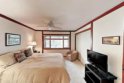a bedroom with a bed and a flat screen tv at Lake Tahoe Oasis in Kings Beach