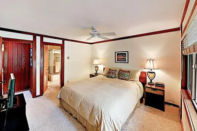 a bedroom with a bed and a ceiling fan at Lake Tahoe Oasis in Kings Beach