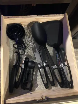 a wooden box with cooking utensils in it at Parked RV Travel Trailer Getaway Wi-Fi with Hookups in Fresno