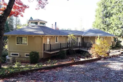 a yellow house with a gambrel roof at Spacious 3BR Retreat - Sleeps 10 - Free Parking in Camino