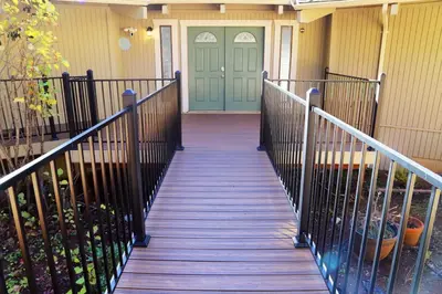 a front door of a house with a wooden walkway at Spacious 3BR Retreat - Sleeps 10 - Free Parking in Camino
