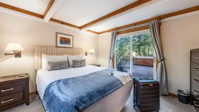 a bedroom with a bed and a large window at Year-Round Tahoe Escape with Hot Tub Outdoor Dining Timberline Haven by AvantStay in Tahoe Vista