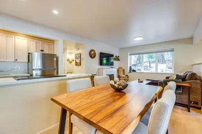 a kitchen and dining room with a wooden table at Walk to Mammoth Village Chic Mountain Studio in Mammoth Lakes