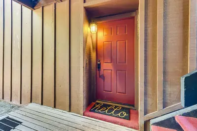 a red door on the side of a building at Walk to Mammoth Village Chic Mountain Studio in Mammoth Lakes