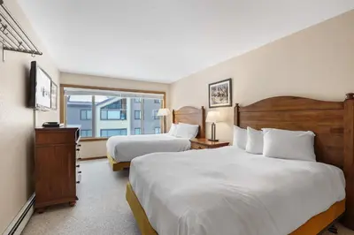 a hotel room with two beds and a window at 2 Bedroom Kirkwood Condo – Across the Street from Village condo in Kirkwood