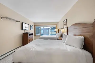 a hotel room with two beds and a window at 2 Bedroom Kirkwood Condo – Across the Street from Village condo in Kirkwood